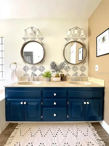 a bathroom with a sink vanity and mirror
