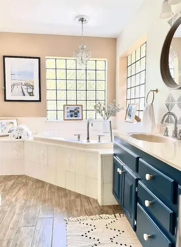 a spacious bathroom with a sink double vanity and a window
