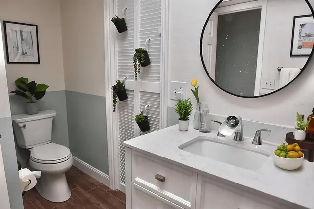 a bathroom with a toilet sink and mirror
