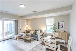 31 Ridge Street, Unit 304 Worcester, MA 01604 - Photo 2 of 3 a living room with furniture and a large window