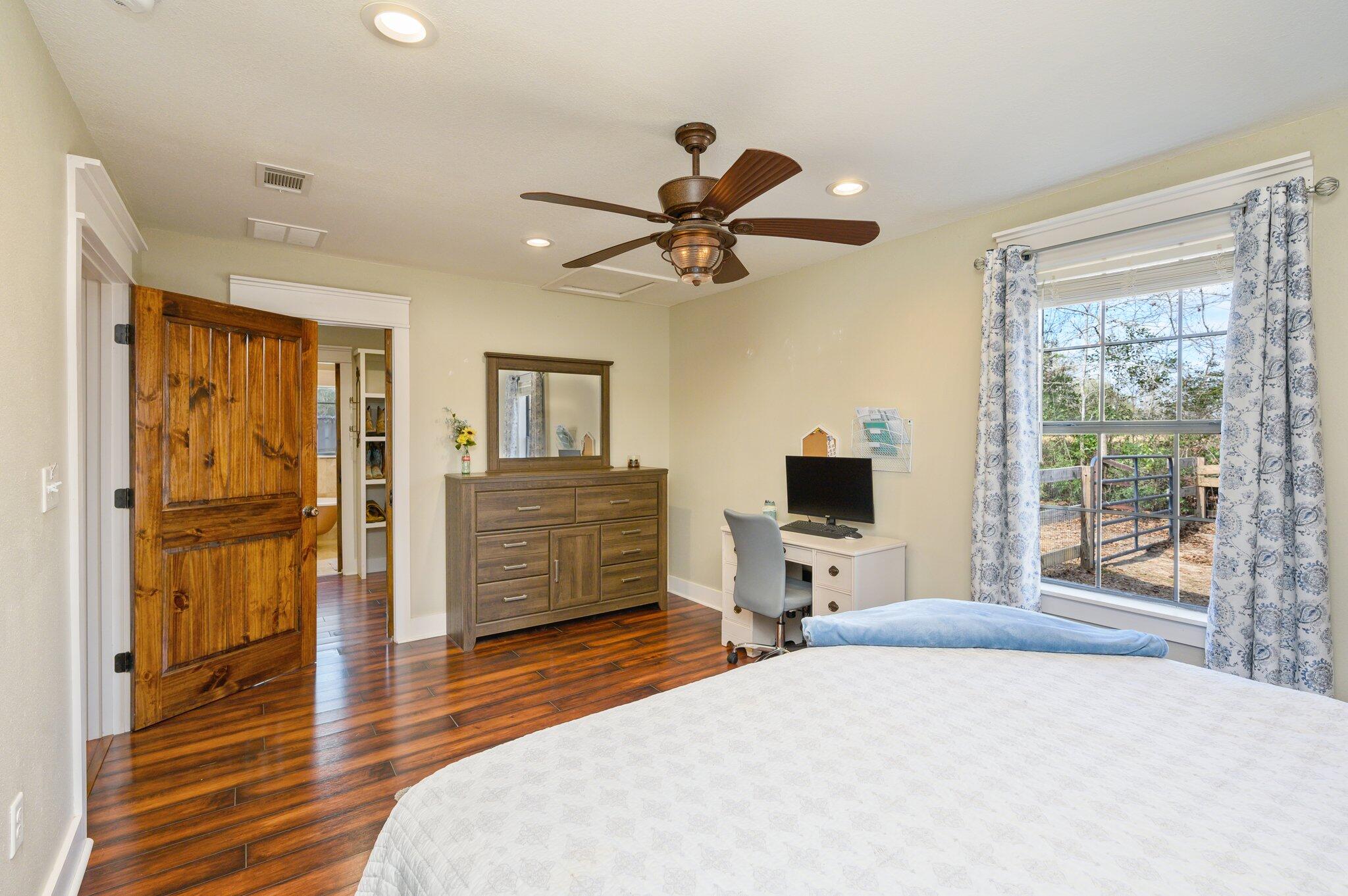 610 Jones Road Crestview, FL 32536 - Photo 17 of 39 a bedroom with a bed and wooden floor
