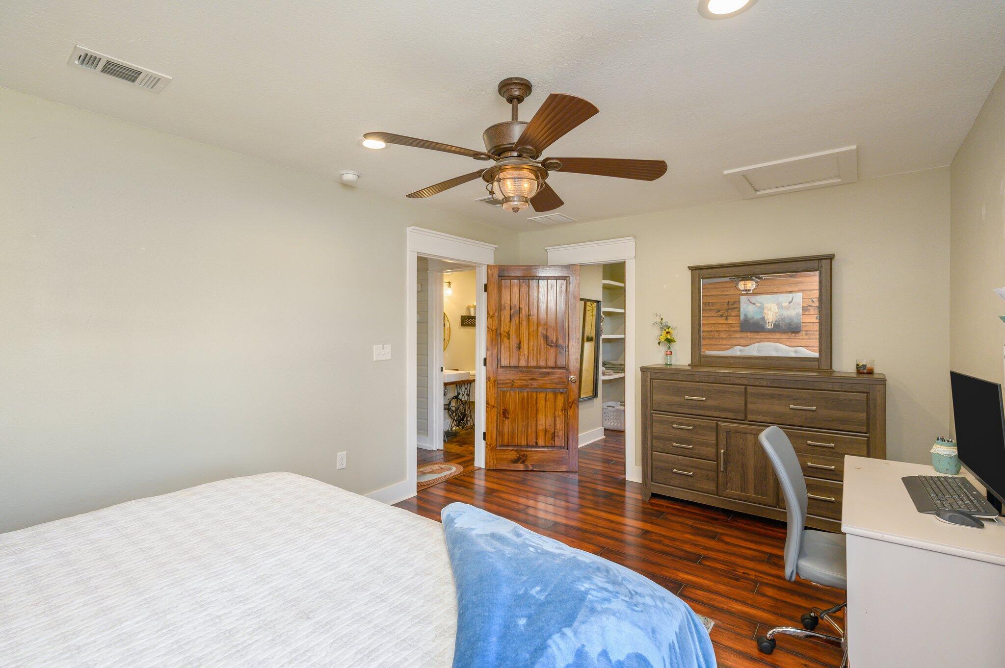 610 Jones Road Crestview, FL 32536 - Photo 18 of 39 a bedroom with a bed and wooden floor