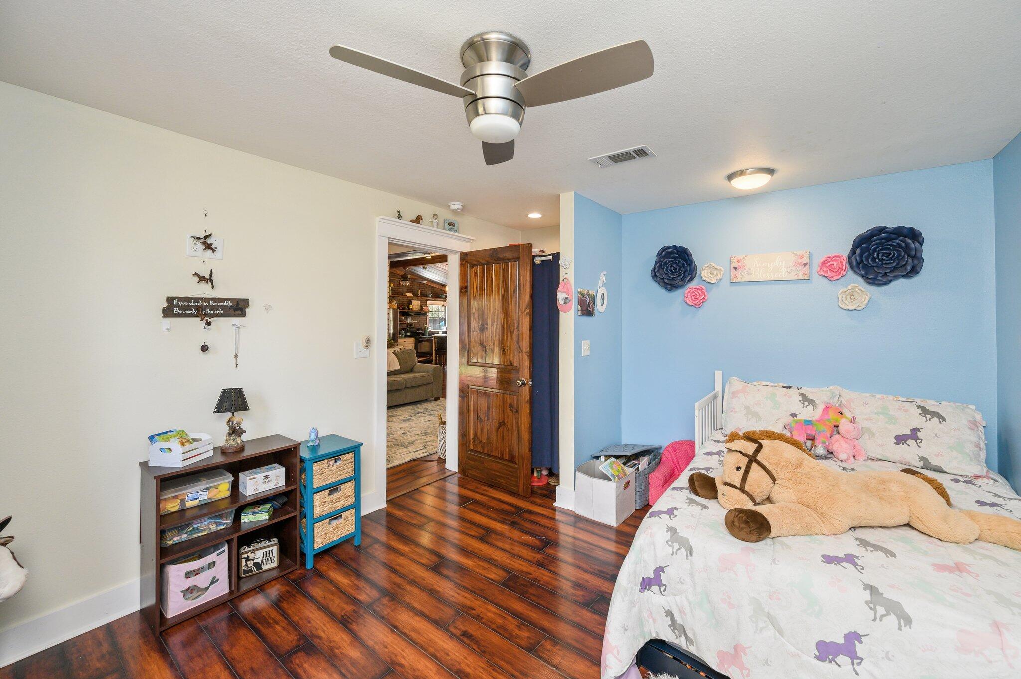 610 Jones Road Crestview, FL 32536 - Photo 29 of 39 a bedroom with a bed and wooden floor