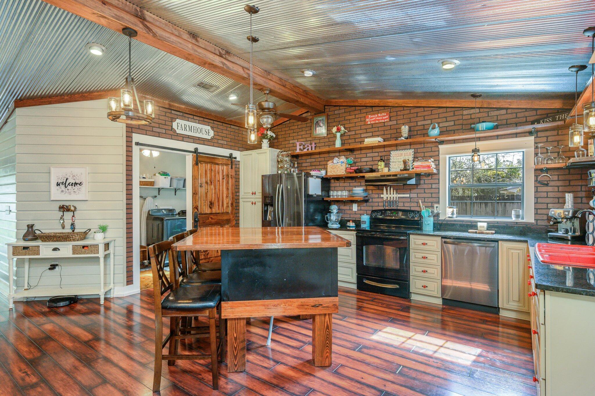 610 Jones Road Crestview, FL 32536 - Photo 6 of 39 a room with stainless steel appliances kitchen island granite countertop a stove and white cabinets