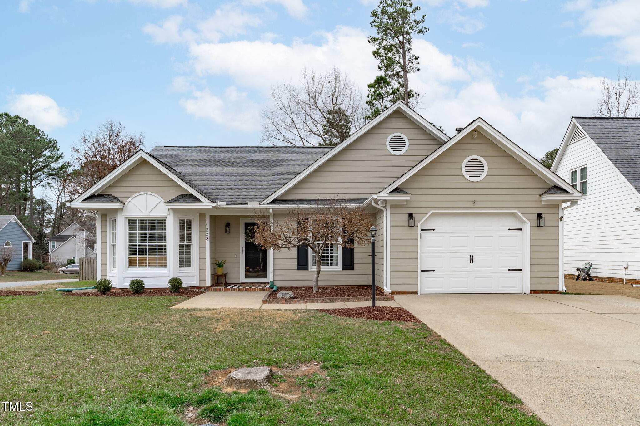 11228 North Radner Way Raleigh, NC 27613 - Photo 1 of 34 a front view of a house with a yard