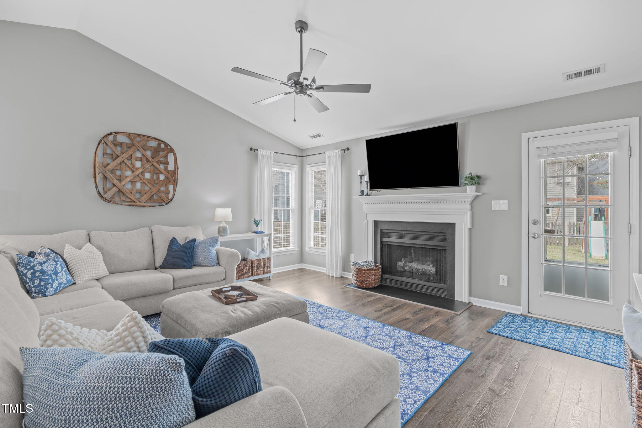 11228 North Radner Way Raleigh, NC 27613 - Photo 14 of 34 a living room with furniture a flat screen tv and a fireplace