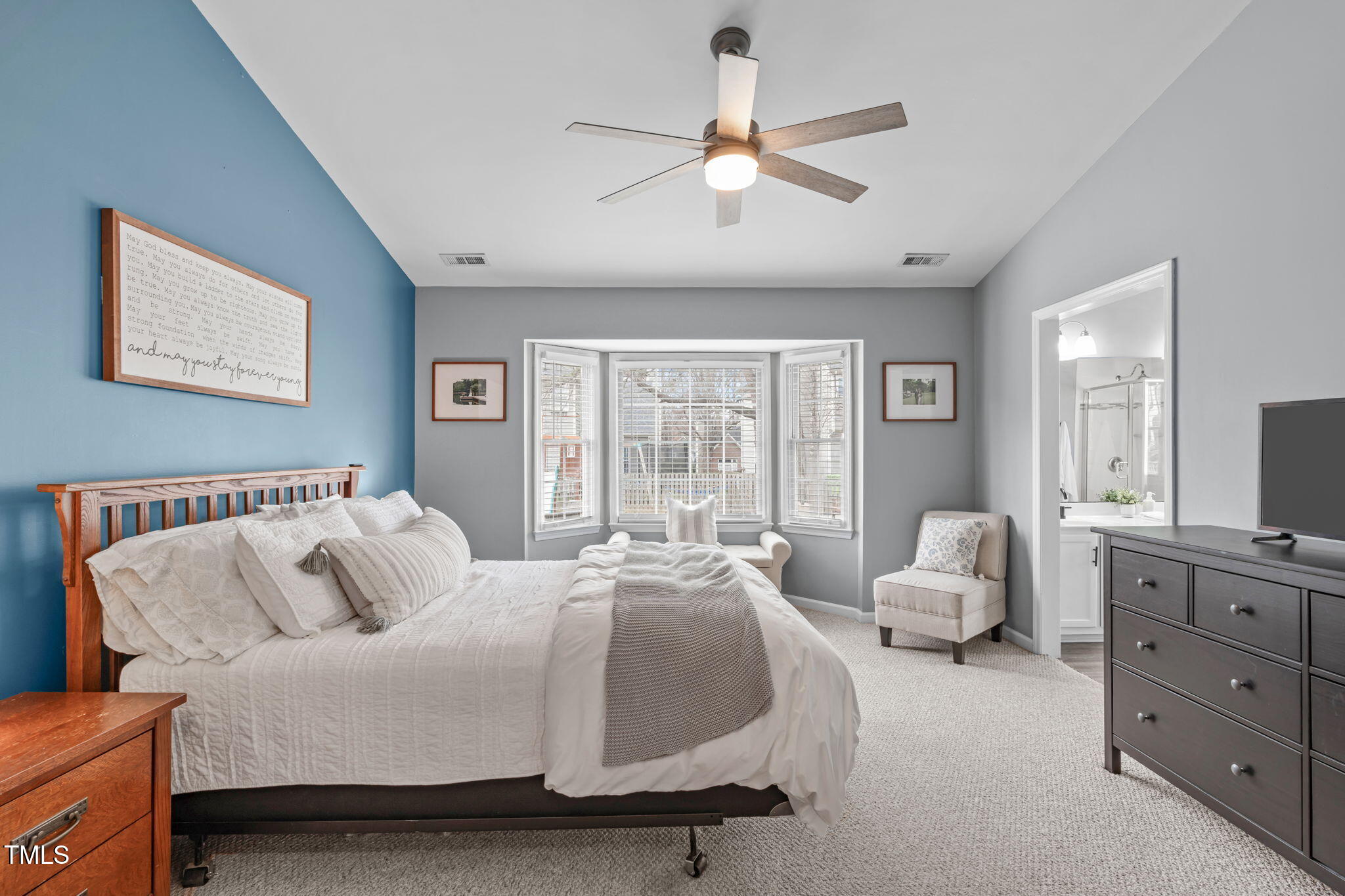 11228 North Radner Way Raleigh, NC 27613 - Photo 18 of 34 a spacious bedroom with a bed couches and a flat tv screen