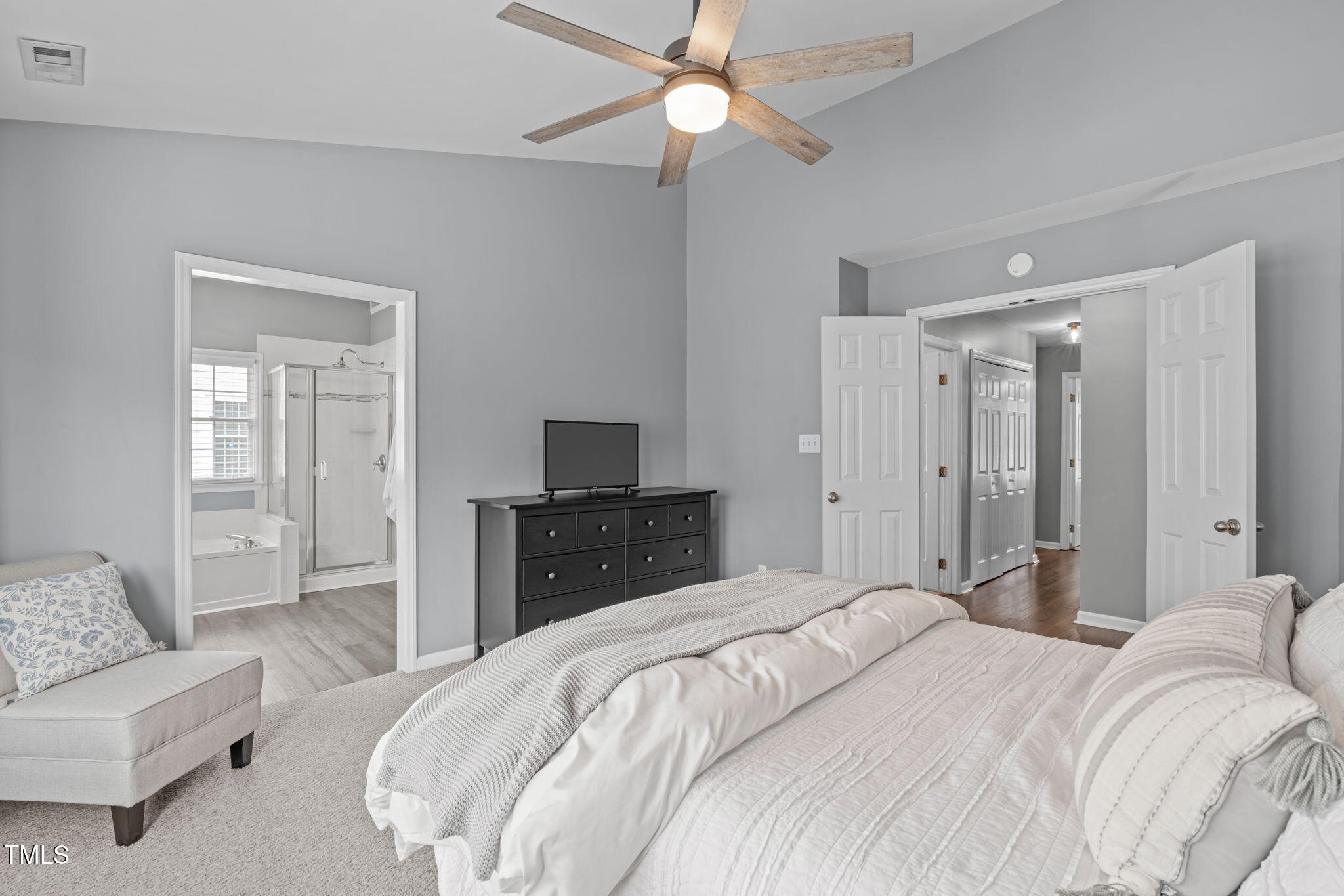 11228 North Radner Way Raleigh, NC 27613 - Photo 19 of 34 a bedroom with a bed and a chandelier