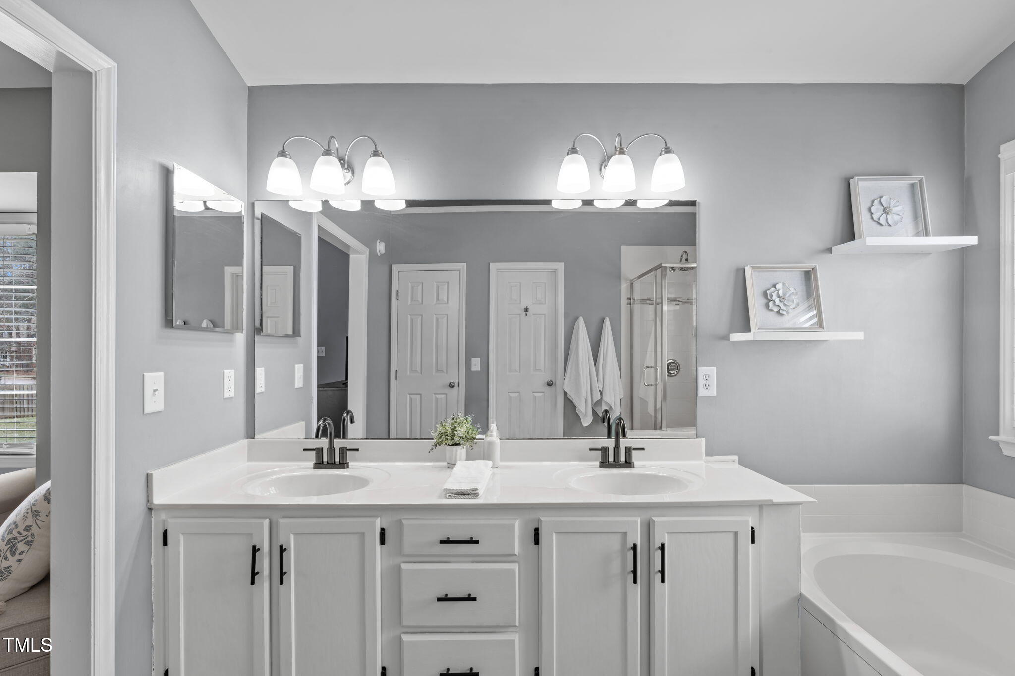 11228 North Radner Way Raleigh, NC 27613 - Photo 21 of 34 a bathroom with a sink double vanity and a mirror