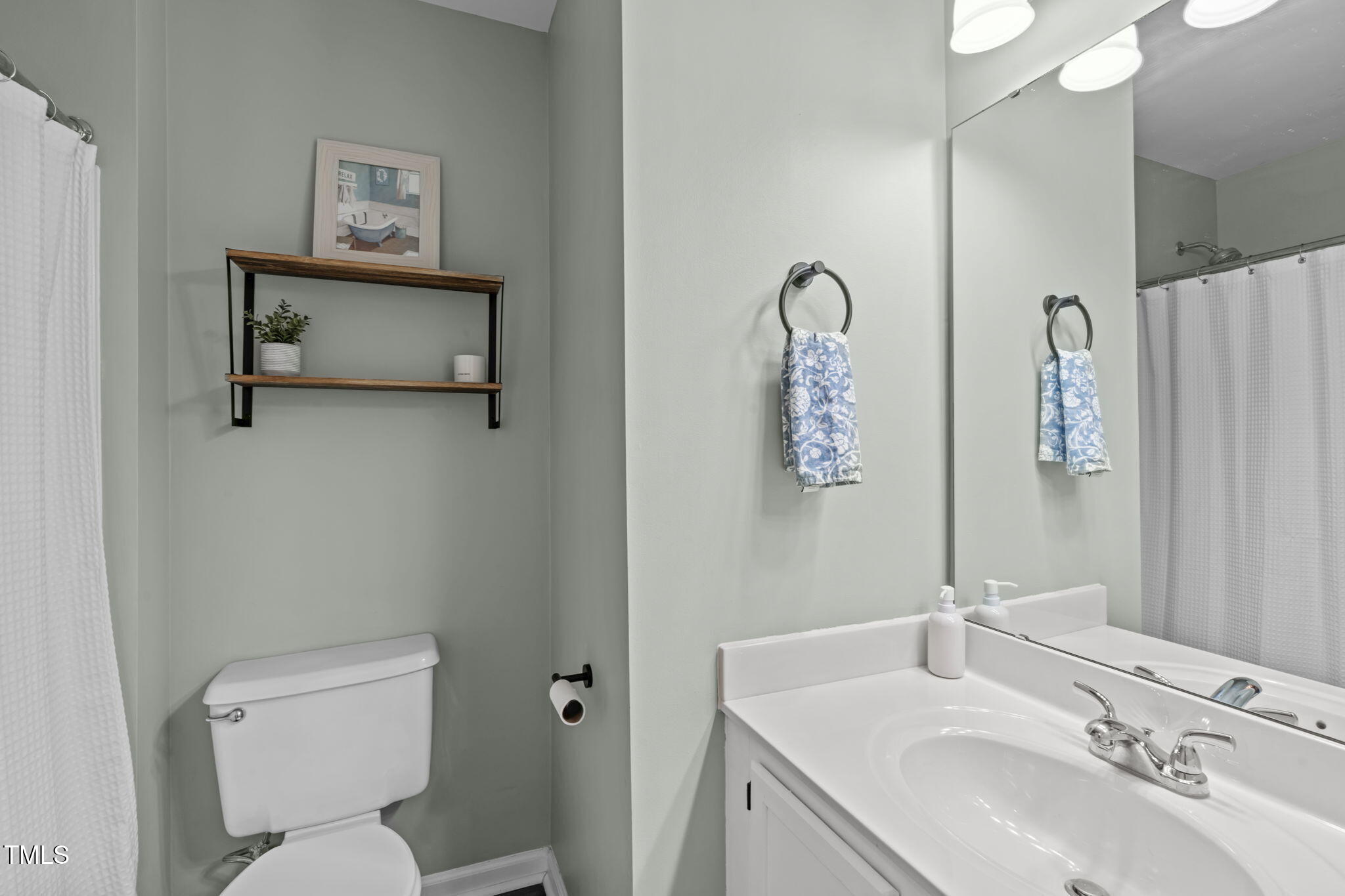 11228 North Radner Way Raleigh, NC 27613 - Photo 25 of 34 a bathroom with a toilet sink and mirror