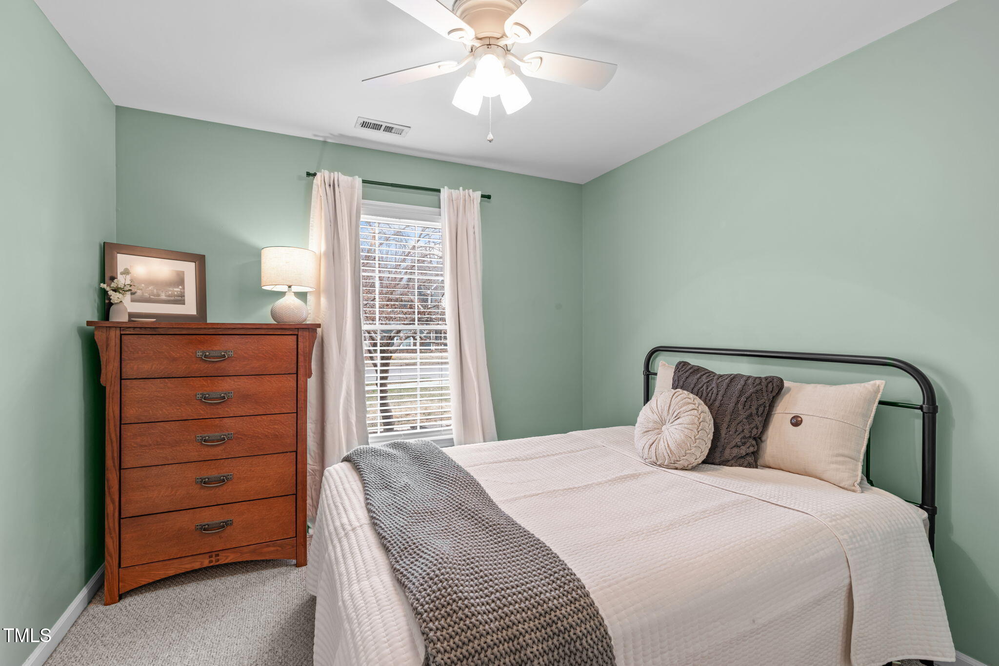 11228 North Radner Way Raleigh, NC 27613 - Photo 26 of 34 a bedroom with a bed and a dresser