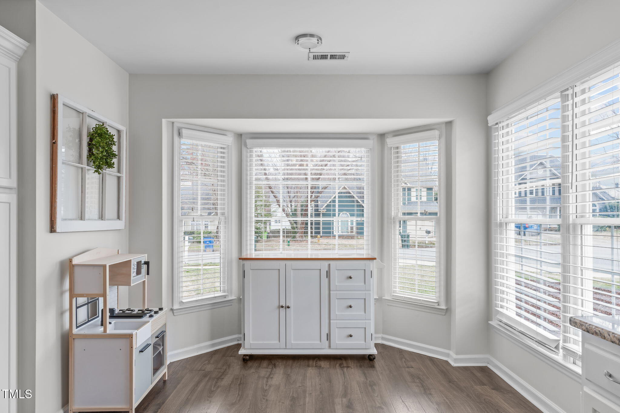 11228 North Radner Way Raleigh, NC 27613 - Photo 9 of 34 a view of a room with wooden floor and windows