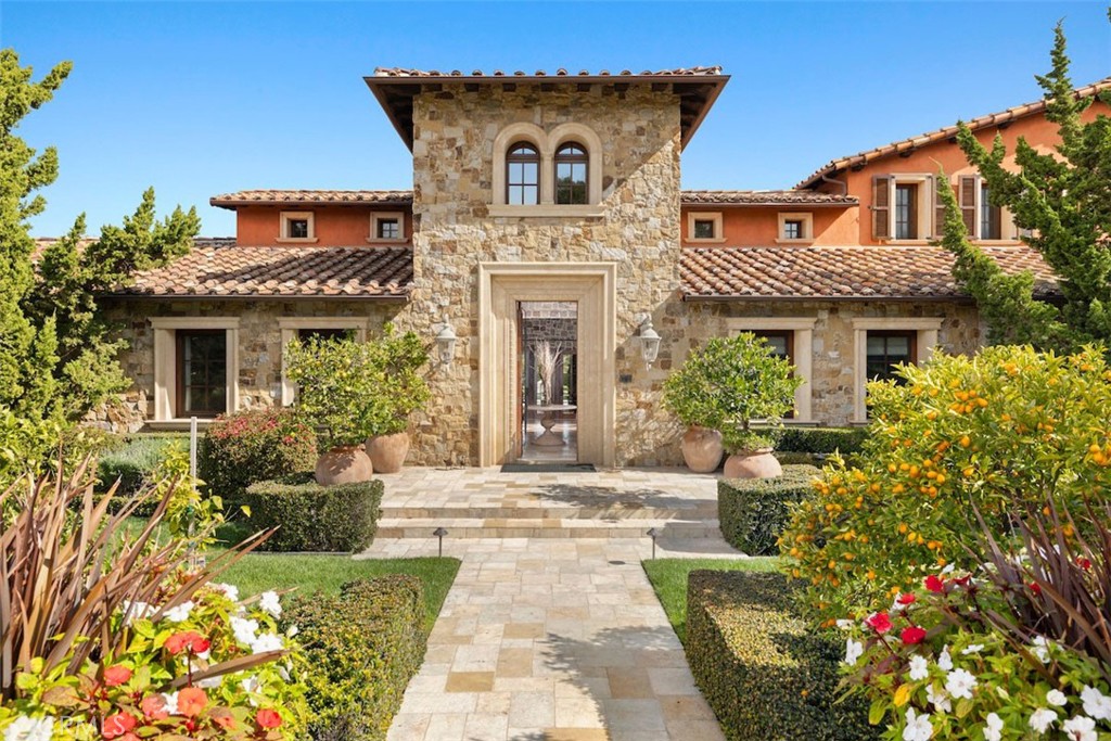a view of a house with potted plants