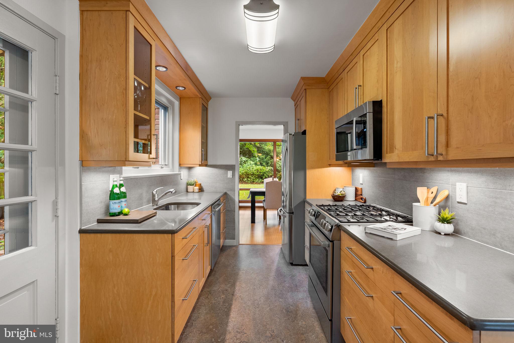 9109 Fairview Road Silver Spring, MD 20910 - Photo 16 of 46 a kitchen with stainless steel appliances granite countertop a sink stove and cabinets