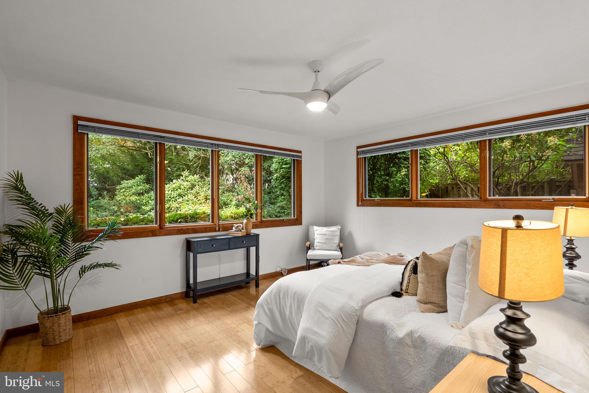 9109 Fairview Road Silver Spring, MD 20910 - Photo 19 of 46 a bedroom with a bed and a large window with outer view