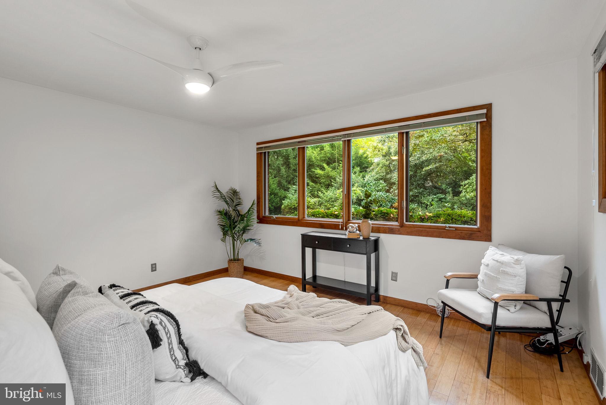 9109 Fairview Road Silver Spring, MD 20910 - Photo 21 of 46 a bedroom with a bed and a large window