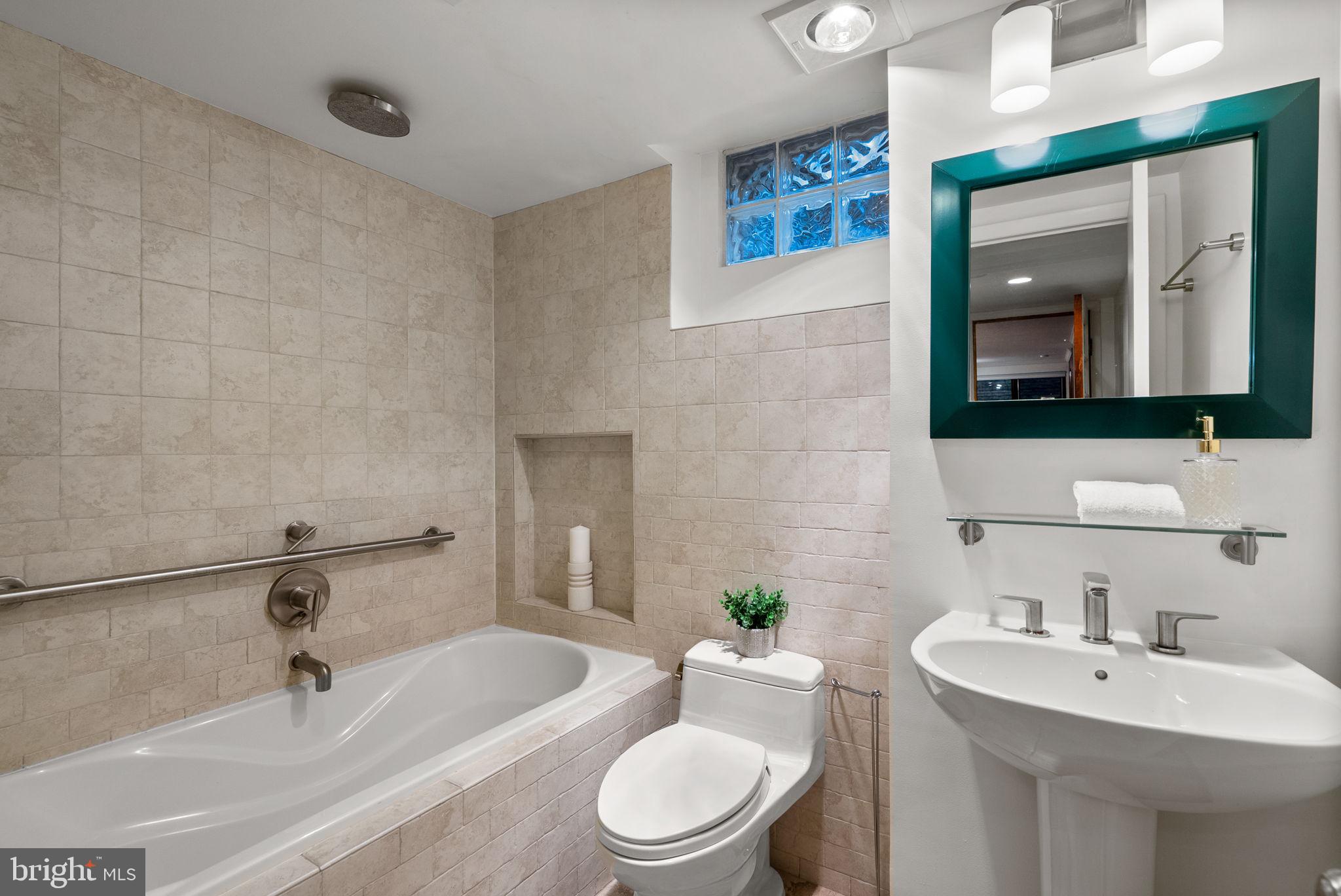 9109 Fairview Road Silver Spring, MD 20910 - Photo 38 of 46 a bathroom with a sink a toilet and mirror