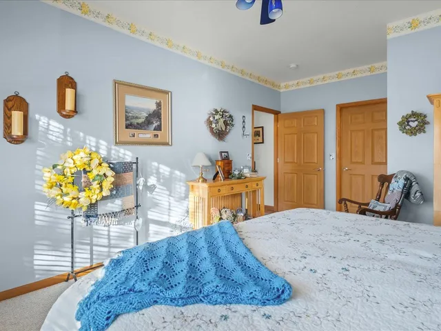 a bedroom with a bed dresser and a large mirror