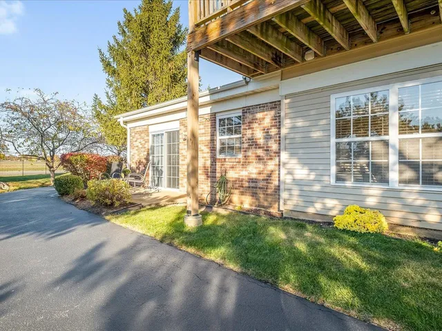 a view of a house with backyard and sitting area