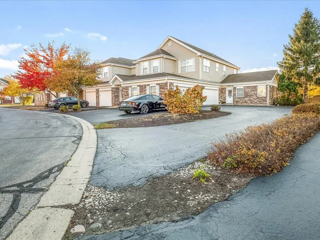 a front view of a house with a yard and a garden