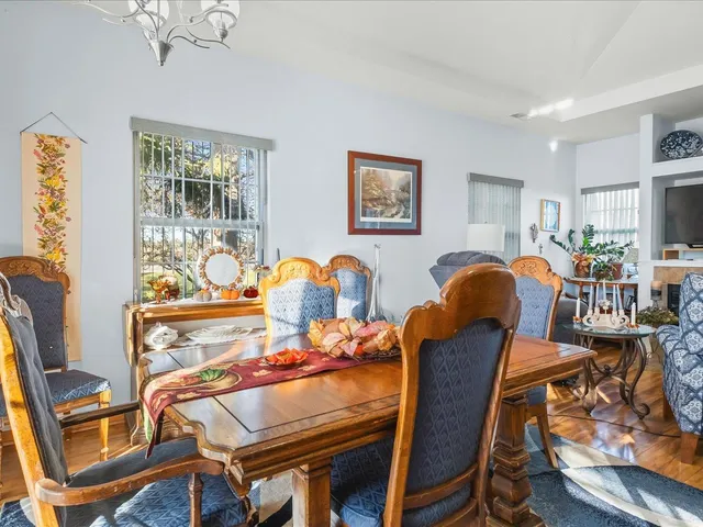 a dining room with furniture and wooden floor