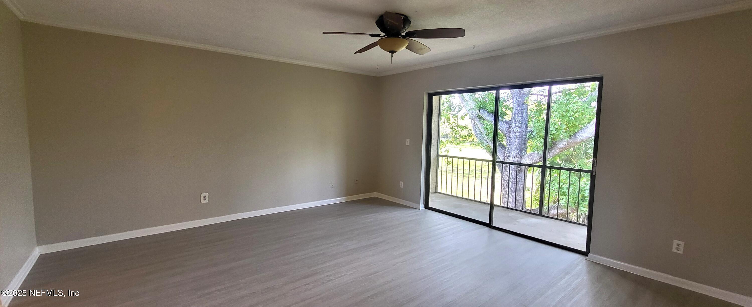 600 Domenico Circle, Unit A12 St. Augustine, FL 32086 - Photo 2 of 11 wooden floor in an empty room with a window