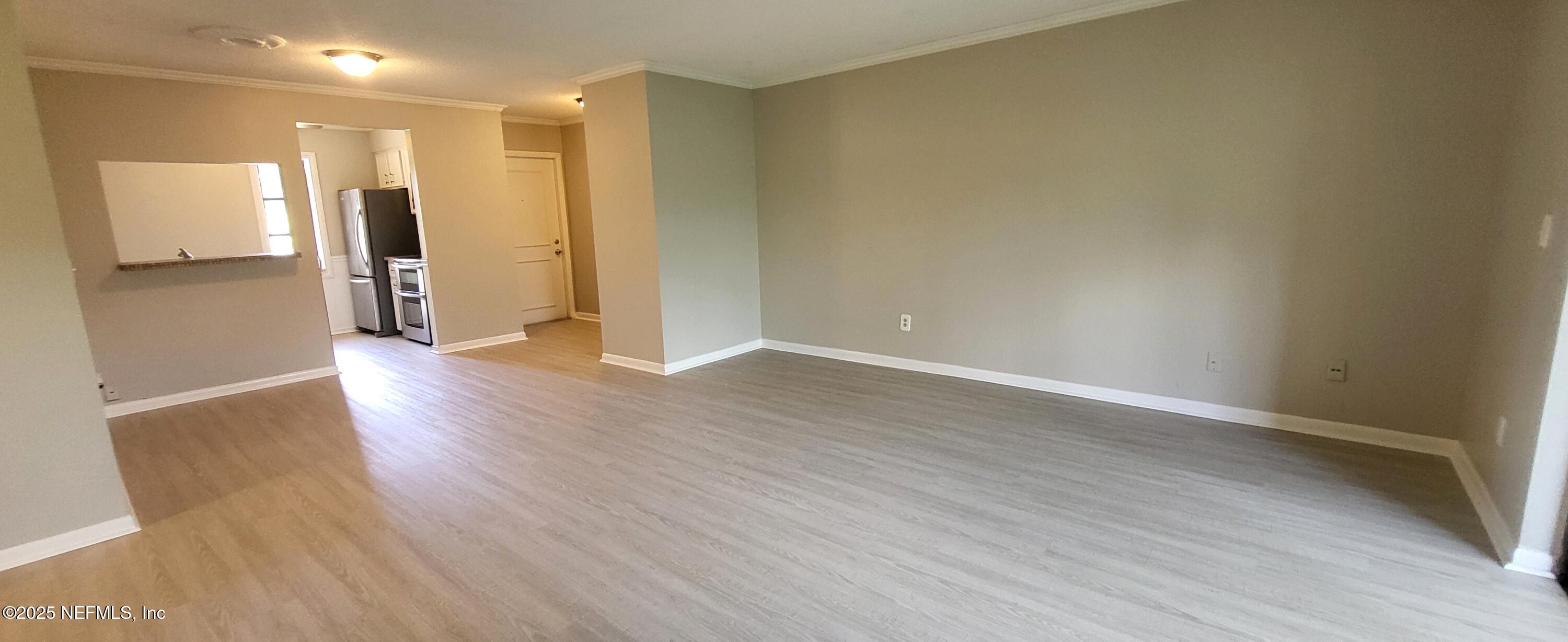 600 Domenico Circle, Unit A12 St. Augustine, FL 32086 - Photo 3 of 11 a view of a hallway with wooden floor