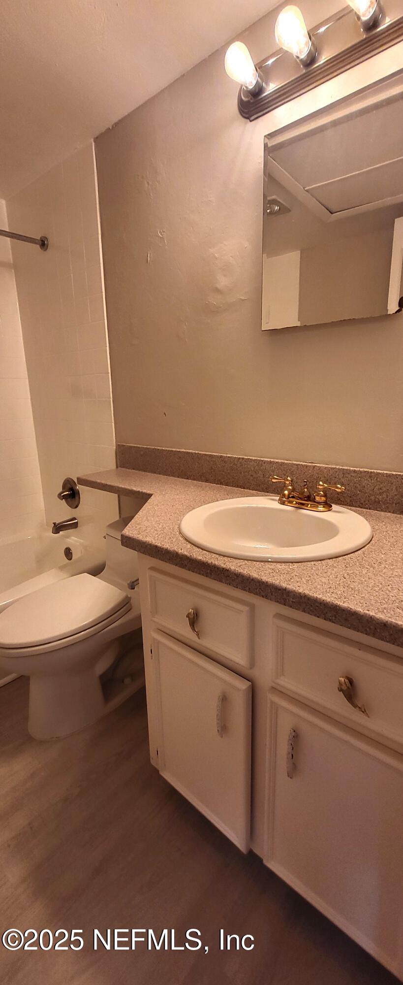 600 Domenico Circle, Unit A12 St. Augustine, FL 32086 - Photo 9 of 11 a bathroom with a sink and a mirror