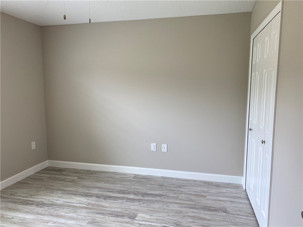 109 Aetna Street, Unit B Sebastian, FL 32958 - Photo 16 of 26 a view of empty room with wooden floor