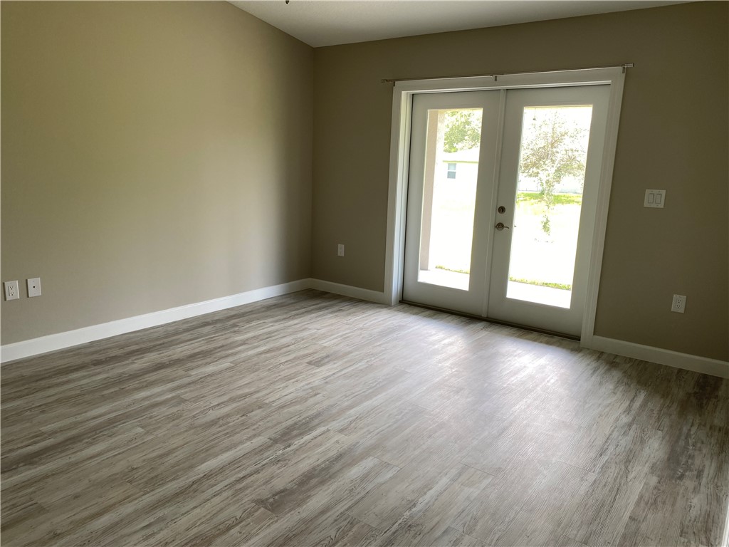 109 Aetna Street, Unit B Sebastian, FL 32958 - Photo 19 of 26 a view of a livingroom with wooden floor and a window