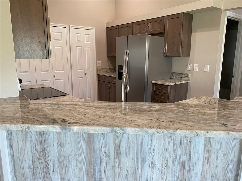 109 Aetna Street, Unit B Sebastian, FL 32958 - Photo 6 of 26 a kitchen with stainless steel appliances granite countertop a refrigerator and a sink