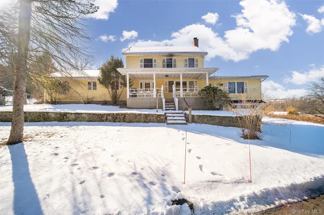 a view of a house with wooden fence