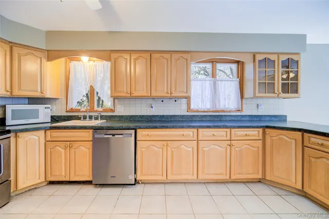 a kitchen with stainless steel appliances granite countertop a sink and cabinets