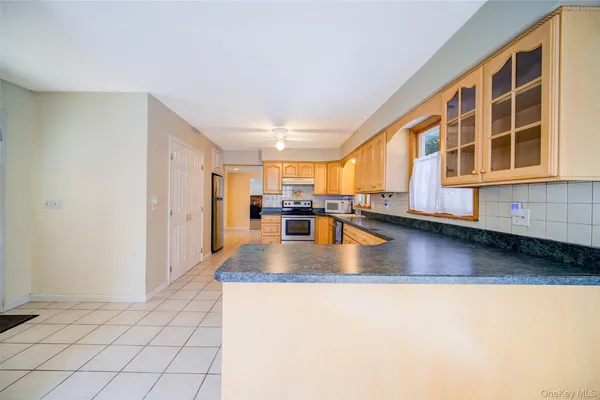 a view of living room with kitchen island granite countertop furniture and a kitchen view