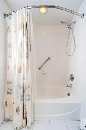 a bathroom with a shower and a shower