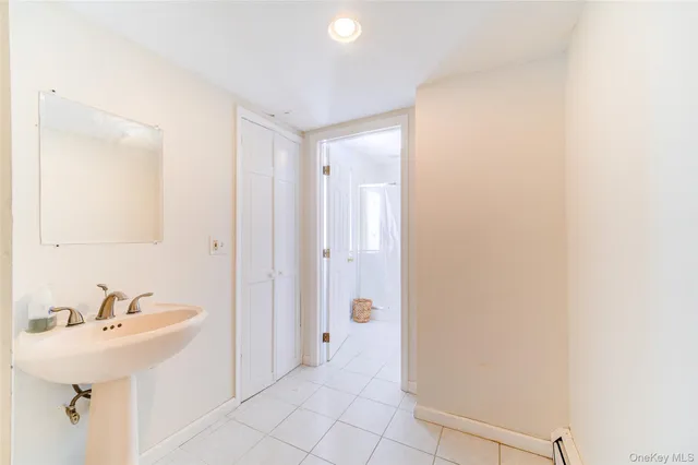 a bathroom with a sink a mirror and a shower