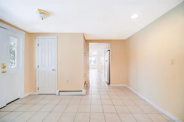 an empty room with windows and closet