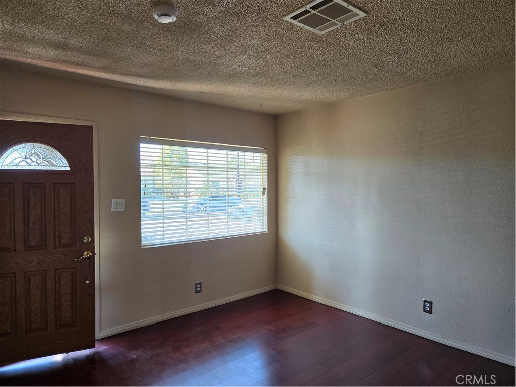 11816 Arlee Avenue Norwalk, CA 90650 - Photo 12 of 30 an empty room with wooden floor and windows