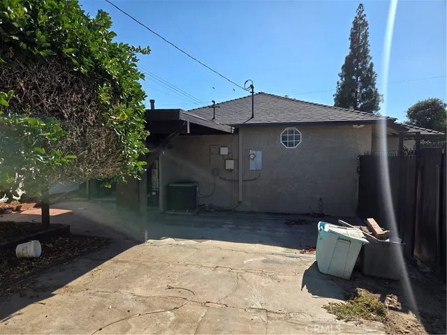 a view of a house with a door and wooden bench