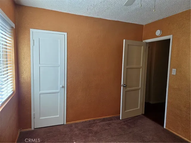 an empty room with closet area