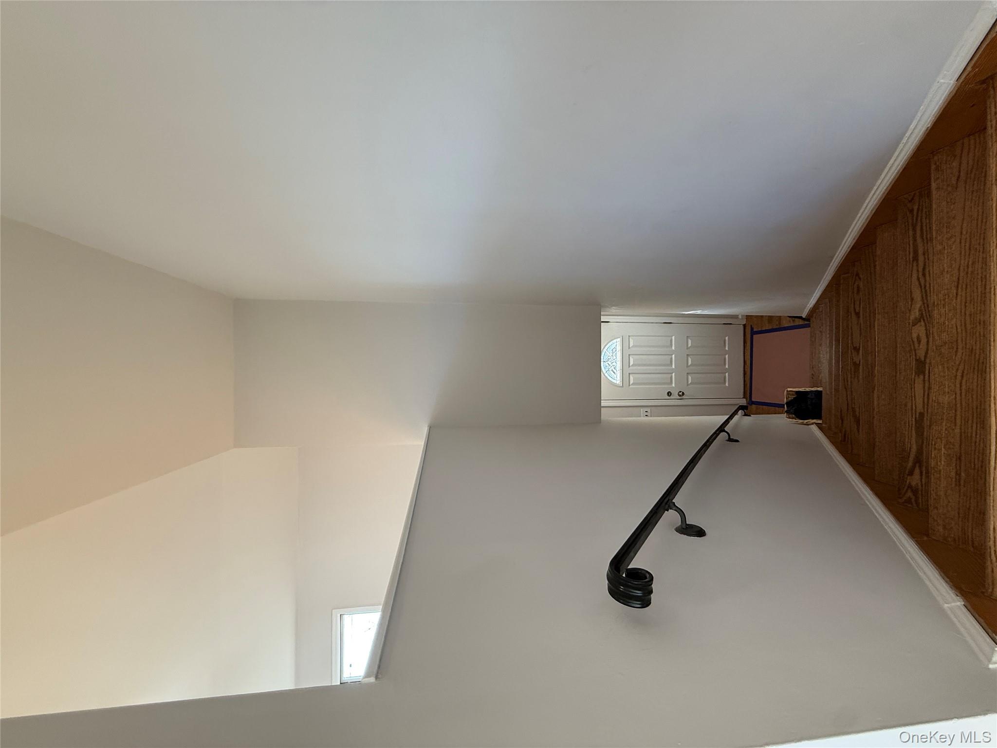 130-09 58th Road Queens, NY 11355 - Photo 9 of 18 Stairway featuring baseboards and a towering ceiling