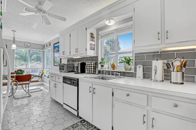 a kitchen with stainless steel appliances granite countertop a sink and cabinets