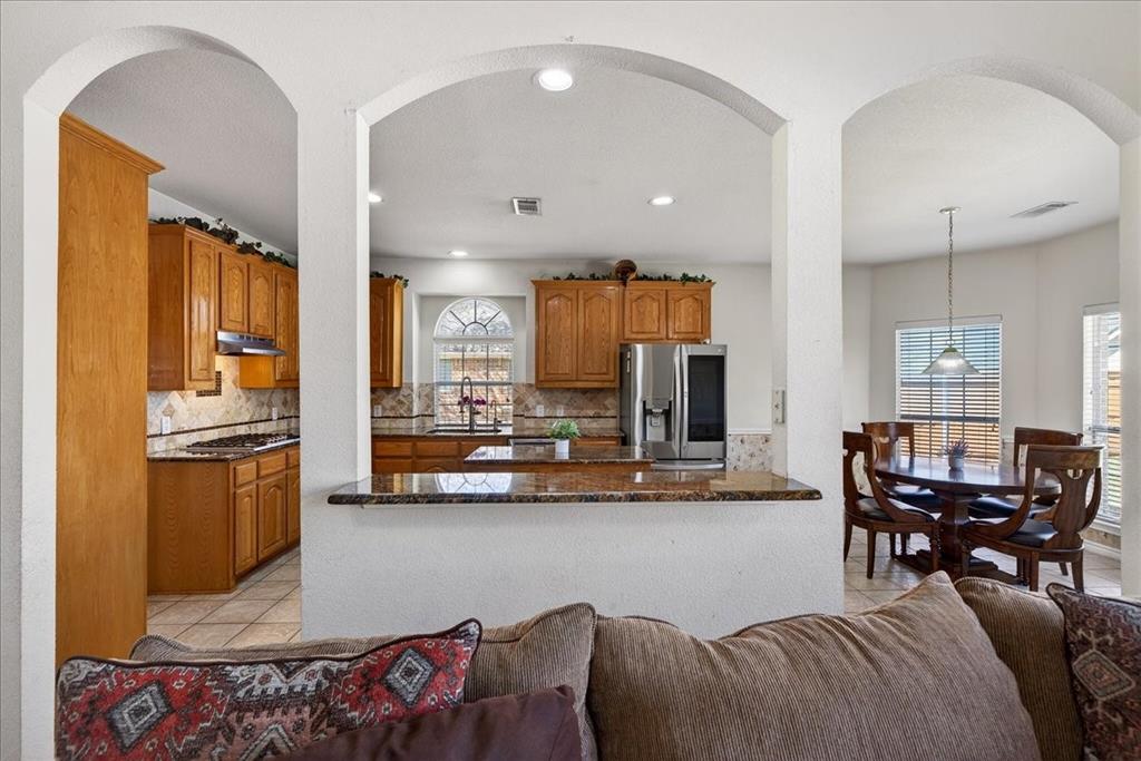 7308 Hawk Lane Sachse, TX 75048 - Photo 14 of 37 a living room with furniture and kitchen view