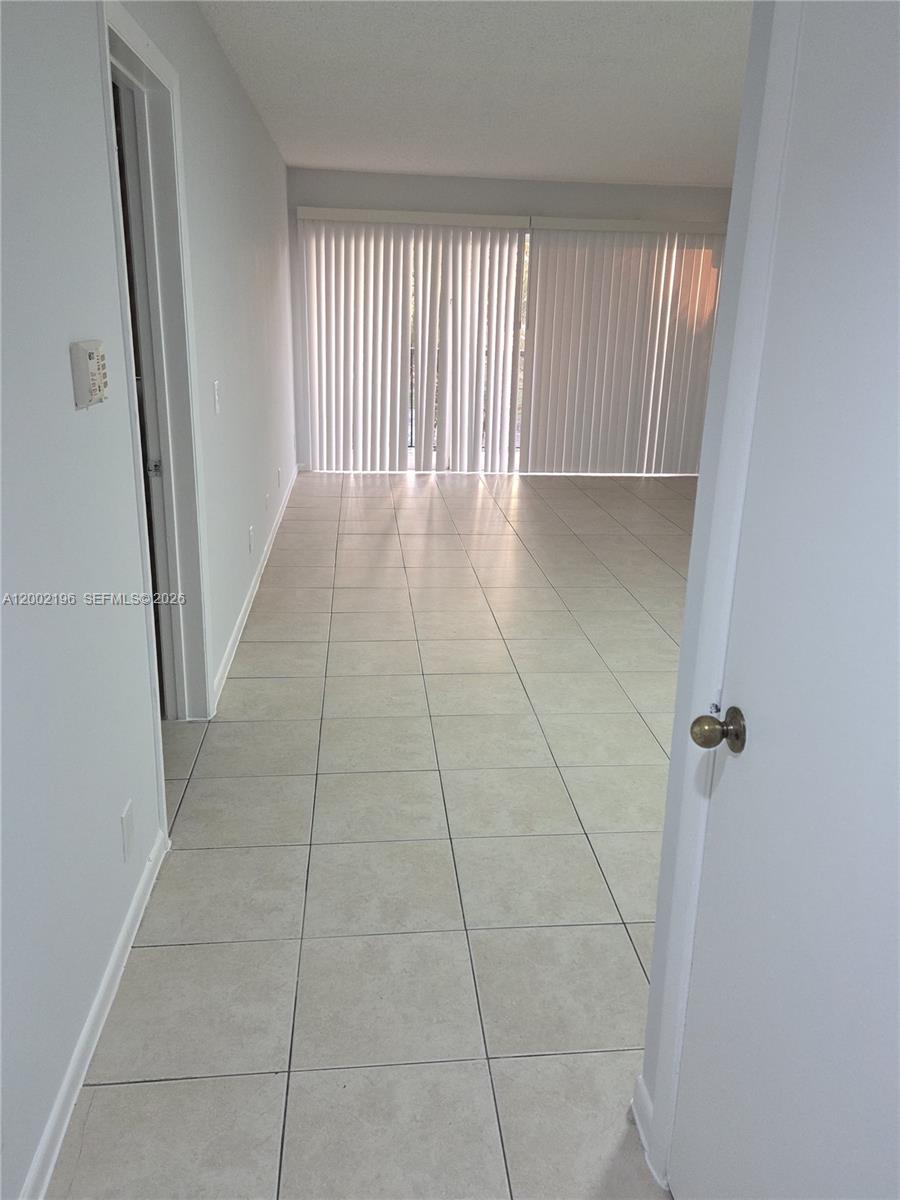 8871 Wiles Road, Unit 208 Coral Springs, FL 33067 - Photo 3 of 15 a view of a hallway
