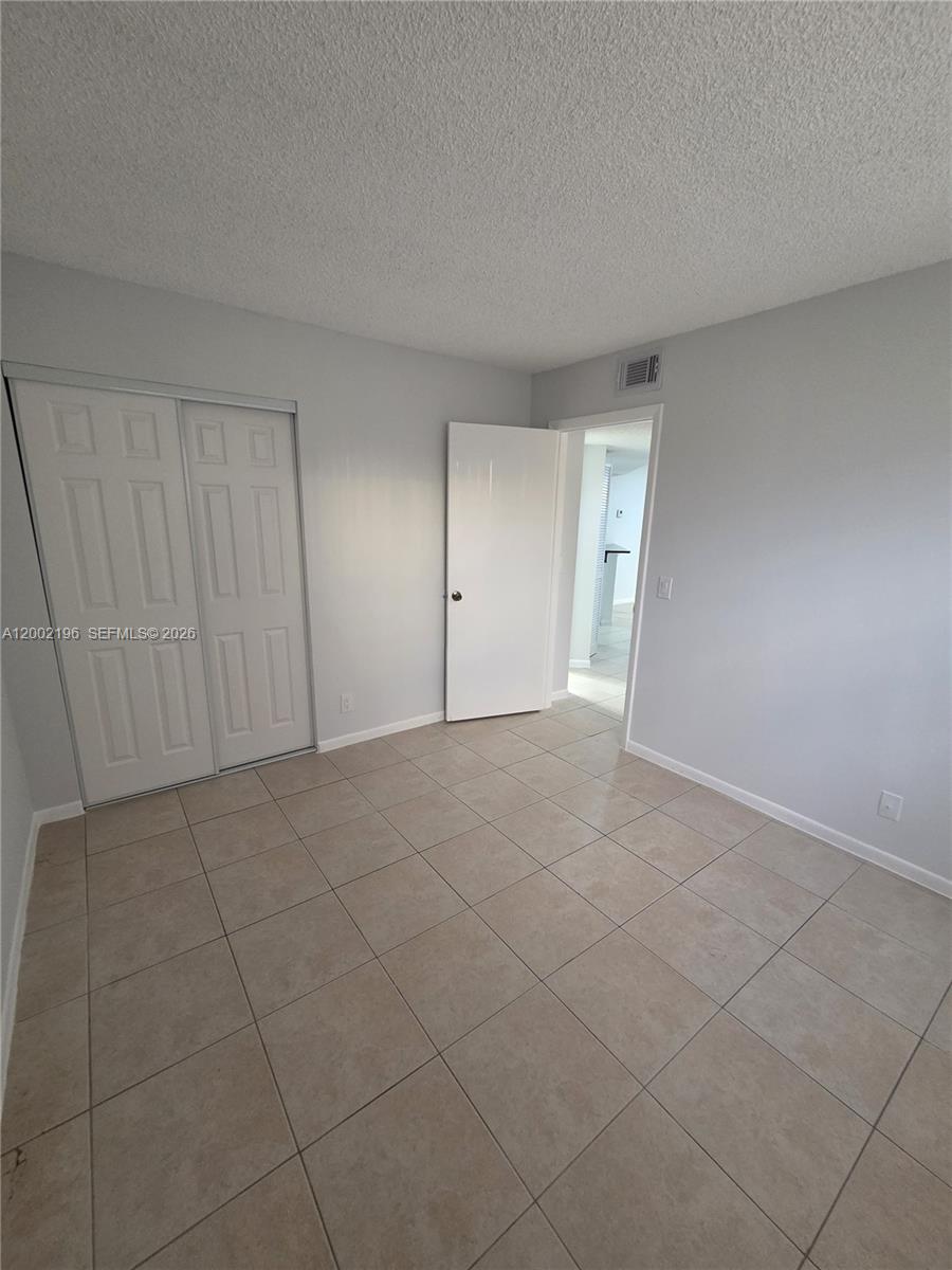 8871 Wiles Road, Unit 208 Coral Springs, FL 33067 - Photo 4 of 15 a view of an empty room and entryway