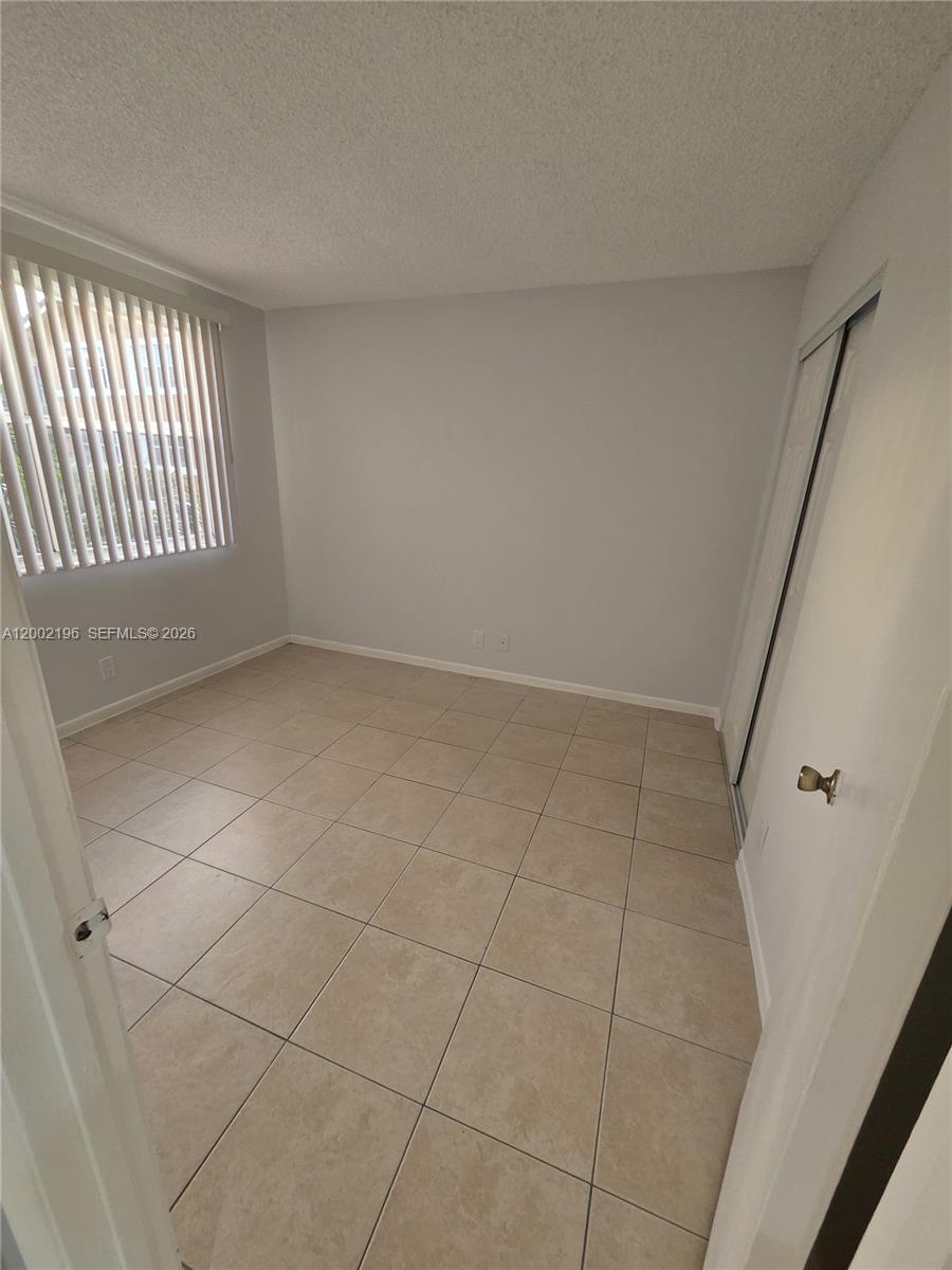 8871 Wiles Road, Unit 208 Coral Springs, FL 33067 - Photo 6 of 15 a view of an empty room with a window
