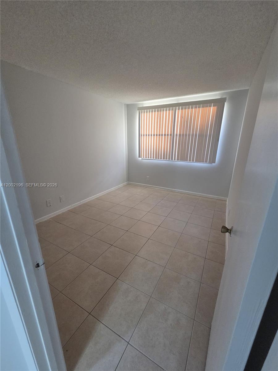 8871 Wiles Road, Unit 208 Coral Springs, FL 33067 - Photo 7 of 15 a view of an empty room with a window