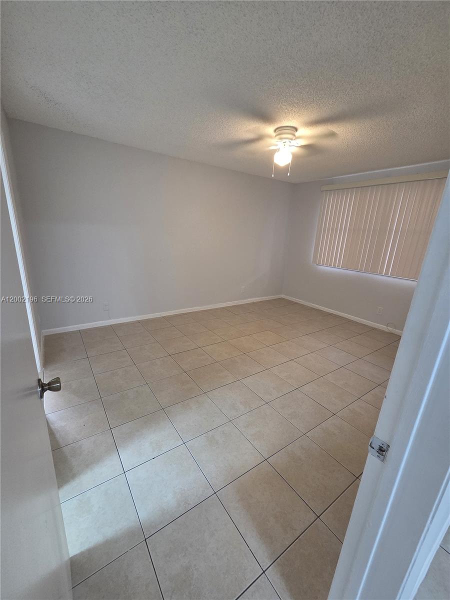 8871 Wiles Road, Unit 208 Coral Springs, FL 33067 - Photo 10 of 15 a view of an empty room with a window