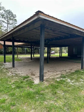 a backyard of a house with table and chairs