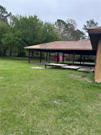 a backyard of a house with yard table and chairs
